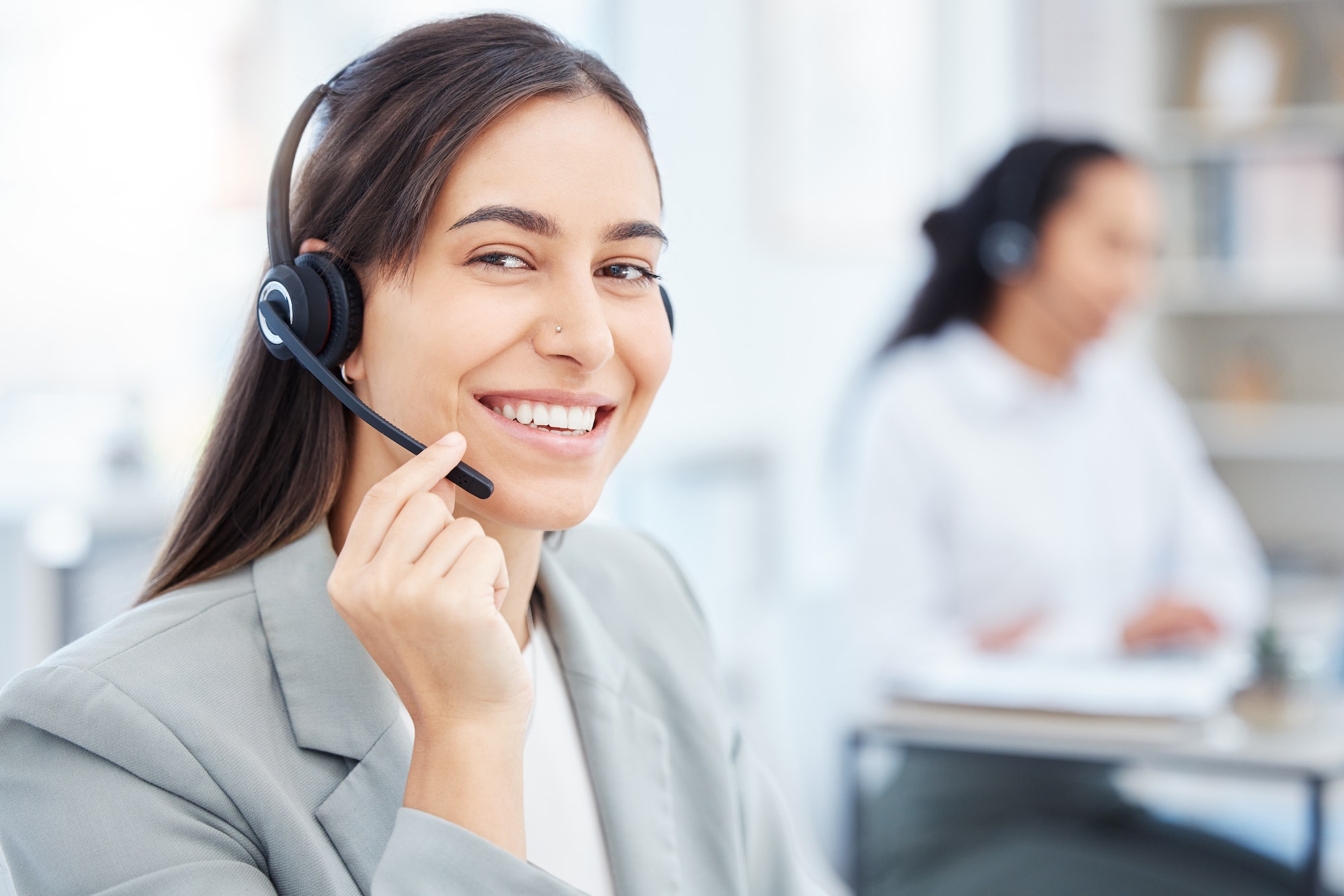 Shot of a young female call center agent working in an office