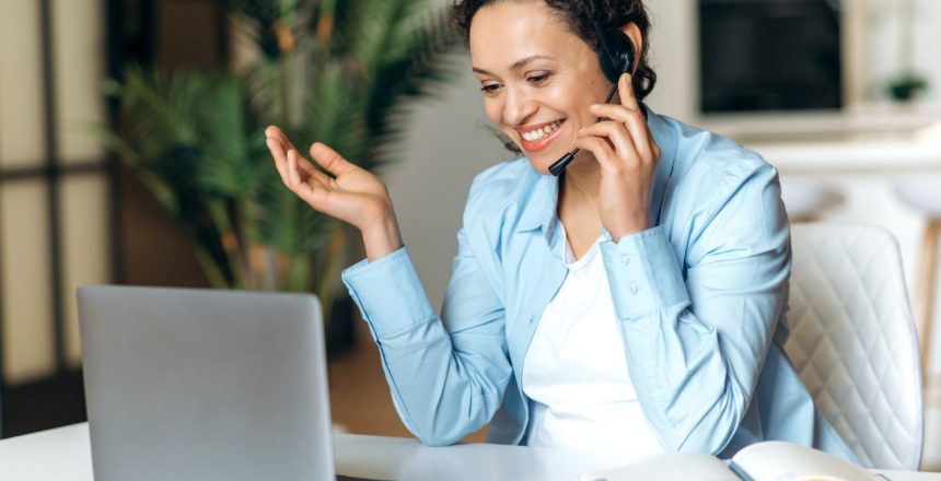 business-woman-mixed-race-headphones-gesturing-smiling-laptop.jpg
